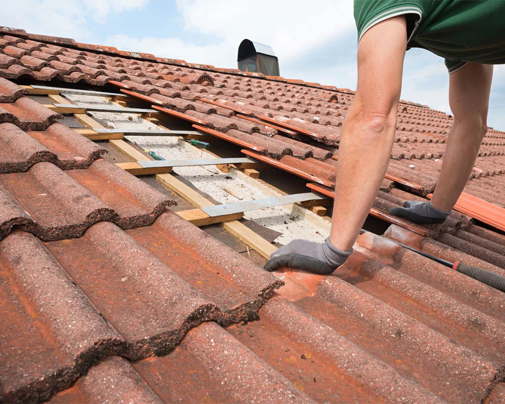 Roofer repairing a leak on a Sun City home, roofing contractor in Sun City, AZ